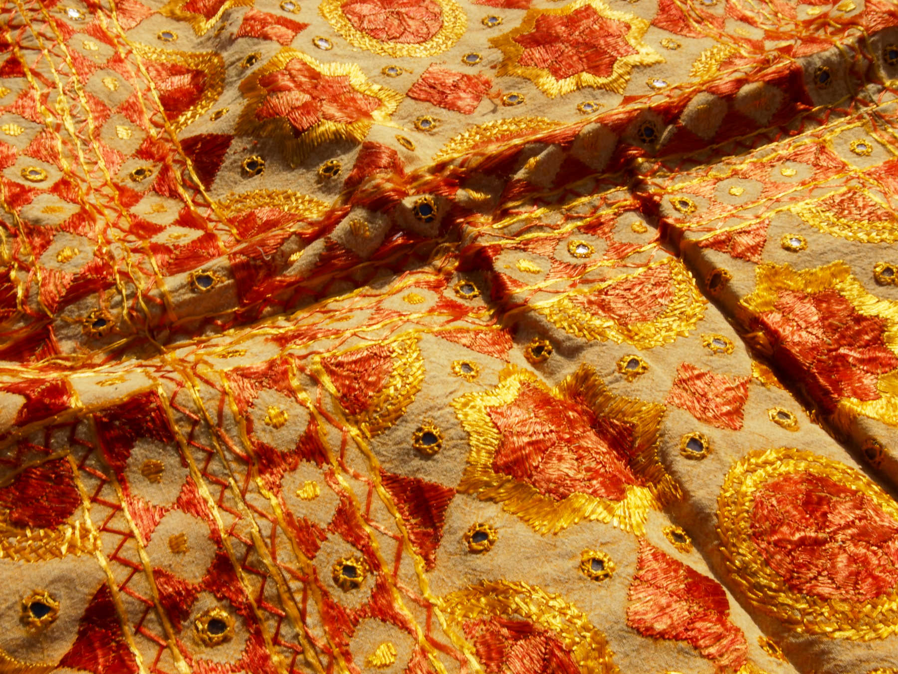 Telo Indiano in cotone doppio strato, ricamato tono su tono con specchietti, giallo e arancio. Può essere impiegato come copridivano, copriletto, tovaglia o tessuto da appendere a parete. Dimensioni 200x230cm